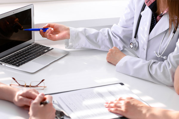 Doctor showing medical progress trakcing on a computer