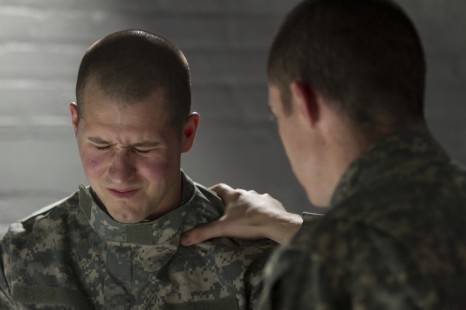 Two army men helping each other with PTSD
